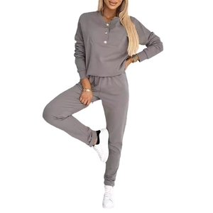 Detail of grey two-piece lounge set featuring a half-button neckline and ribbed cuffs