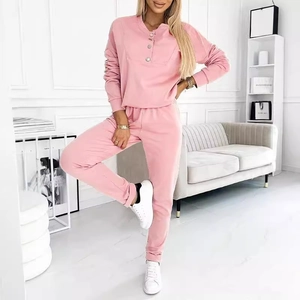 Pink two-piece casual lounge set featuring a long-sleeve buttoned top and matching pants