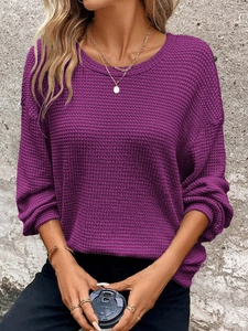 Detail of purple waffle knit sweater featuring dropped shoulders and round neckline