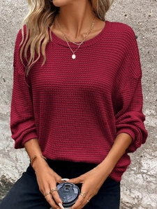Detail of burgundy waffle knit texture on women's loose crewneck pullover sweatshirt