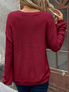 Detail view of burgundy waffle knit sweater back with textured crewneck and drop shoulder