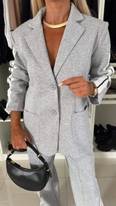 Detail view of grey casual suit with white racing stripes on long sleeves and notch lapel