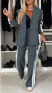 Detail of grey lounge suit with side stripes and elastic high waist wide leg pants