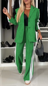 Detail of green suit with white side stripes, lapel collar, and matching wide-leg trousers