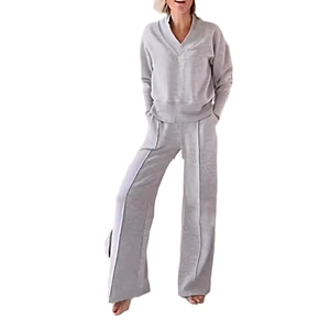 Detail of light gray loungewear set featuring a V-neck top and wide-leg trousers