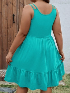 Back view of a turquoise sleeveless dress featuring delicate double straps and a tiered hem