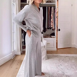 Grey knit two-piece set featuring V-neck long sleeve top and wide-leg pants