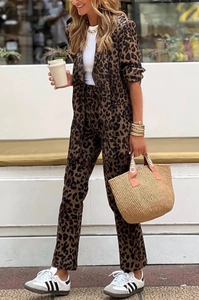 Outdoor street style view of woman wearing a leopard print blazer and trousers set