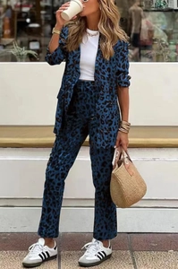 Detail of blue leopard print women suit featuring long sleeve blazer and high waist trousers