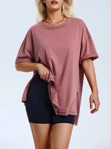 Detail of dry rose pink oversized t-shirt with high side slits and cotton fabric texture