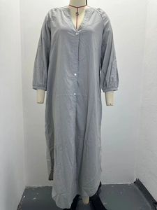Detail of grey cotton linen maxi dress with long sleeves and white buttons down the front