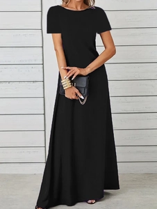 Detail of a minimalist black crew neck maxi dress with short sleeves and A-line skirt flow