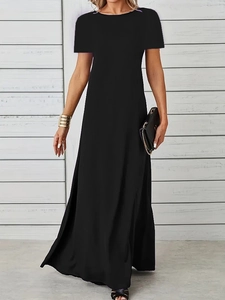Detail of a minimalist black short sleeve maxi dress with crew neck and A-line silhouette