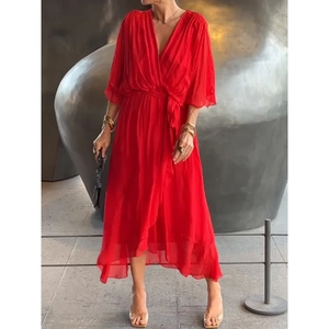 Detail of red V-neck wrap maxi dress with waist tie and irregular cascading hemline