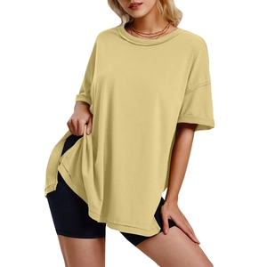 Detail of loose mustard yellow T-shirt showing side split hem and soft cotton fabric
