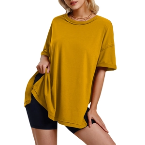 Detail view of mustard yellow loose T-shirt featuring a crew neck and side slit hem design