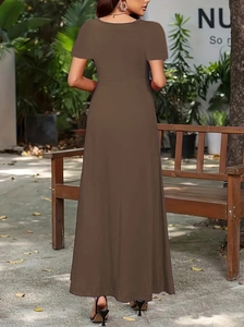 Outdoor back view of a minimalist brown short sleeve A-line maxi dress with round neck