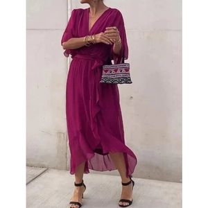 Detail of dark magenta wrap maxi dress with irregular ruffled hem and tie-waist design