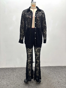 Detail view of black floral lace shirt with white buttons and matching flared trousers