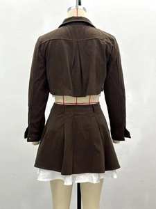 Back view of brown suede two-piece set featuring cropped jacket and pleated mini skirt