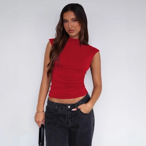 Slim fit sleeveless high neck ruched top in red paired with casual black jeans