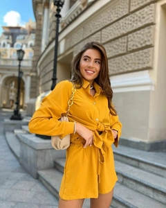 Détail d'un ensemble deux pièces avec chemise à manches longues et short jaune moutarde