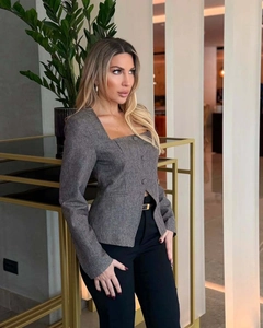 Detail of grey square neck blazer showing texture and decorative buttons for women