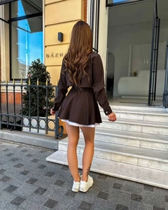 Detail view of the brown two-piece set featuring a cropped jacket and A-line mini skirt