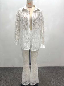 Detailed close-up of white floral lace two-piece set featuring shirt and flare pants