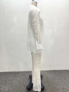 Detailed side view of white floral lace long sleeve shirt and wide leg pants set