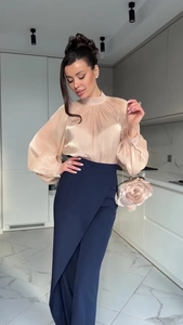 Detail of elegant champagne satin high neck top paired with navy blue overlap skirt