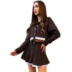 Women's brown corduroy two-piece set with long sleeve jacket and pleated mini skirt