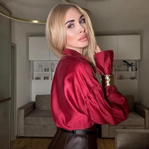 Elegant red satin long sleeve blouse paired with brown leather skirt and belt