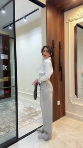 Full view of white vertical striped lapel shirt paired with high waist denim jeans