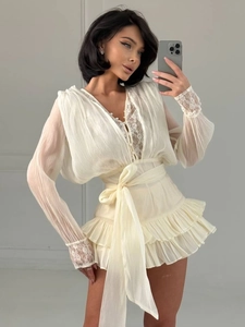 Dettaglio del bordo in pizzo, scollo a V e cintura in vita su un abito di chiffon chic