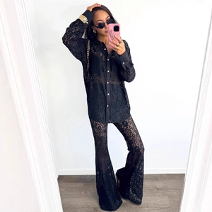 Elegant two-piece black lace set featuring a long sleeve button shirt and flared trousers