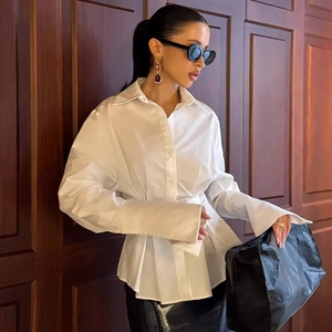 Minimalist pleated white shirt for women featuring a cinched waist and tailored collar