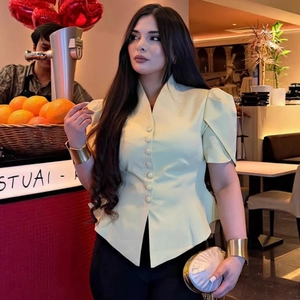 Pale yellow V-neck shirt with puff sleeves and button-down front in a tailored fit