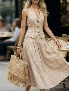 Detail of the chic halter neck top featuring gold buttons and vertical stripes