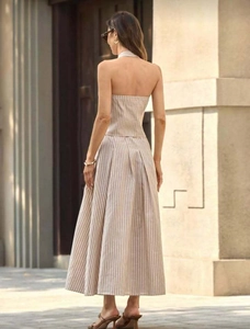 Back view of a striped halter top and pleated maxi skirt set in a resort style