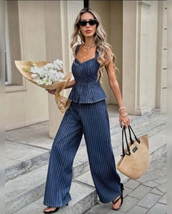 Detail of dark blue striped peplum top and high-waist wide-leg trousers set