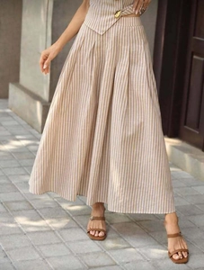Detail view of high waist striped maxi skirt with pleated texture in beige and white