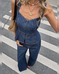 Detail of navy blue pinstripe denim set featuring front zipper and slim-fit camisole top