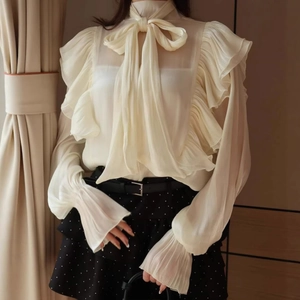 Elegant off-white chiffon blouse with large bow tie collar and tiered ruffle details