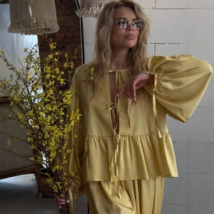 Bright yellow two-piece set featuring lantern sleeve bow-tie top and wide-leg trousers