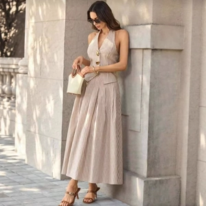 Elegant women's striped two-piece set featuring a halter vest and pleated maxi skirt