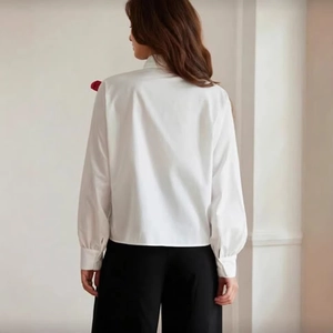 Back view of white long sleeve shirt with 3D bow decoration and stand collar