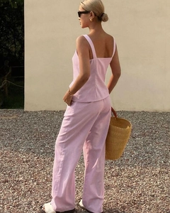 Detail of pink sleeveless button-up top and high-waisted wide-leg pants from the back side