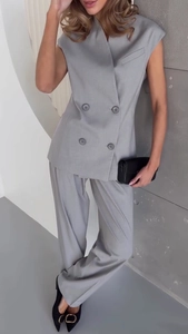 Detail view of double-breasted sleeveless blazer vest and wide-leg pants in grey suit fabric