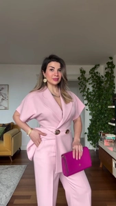 Detail of pink double-breasted short sleeve blazer suit set with matching trousers
